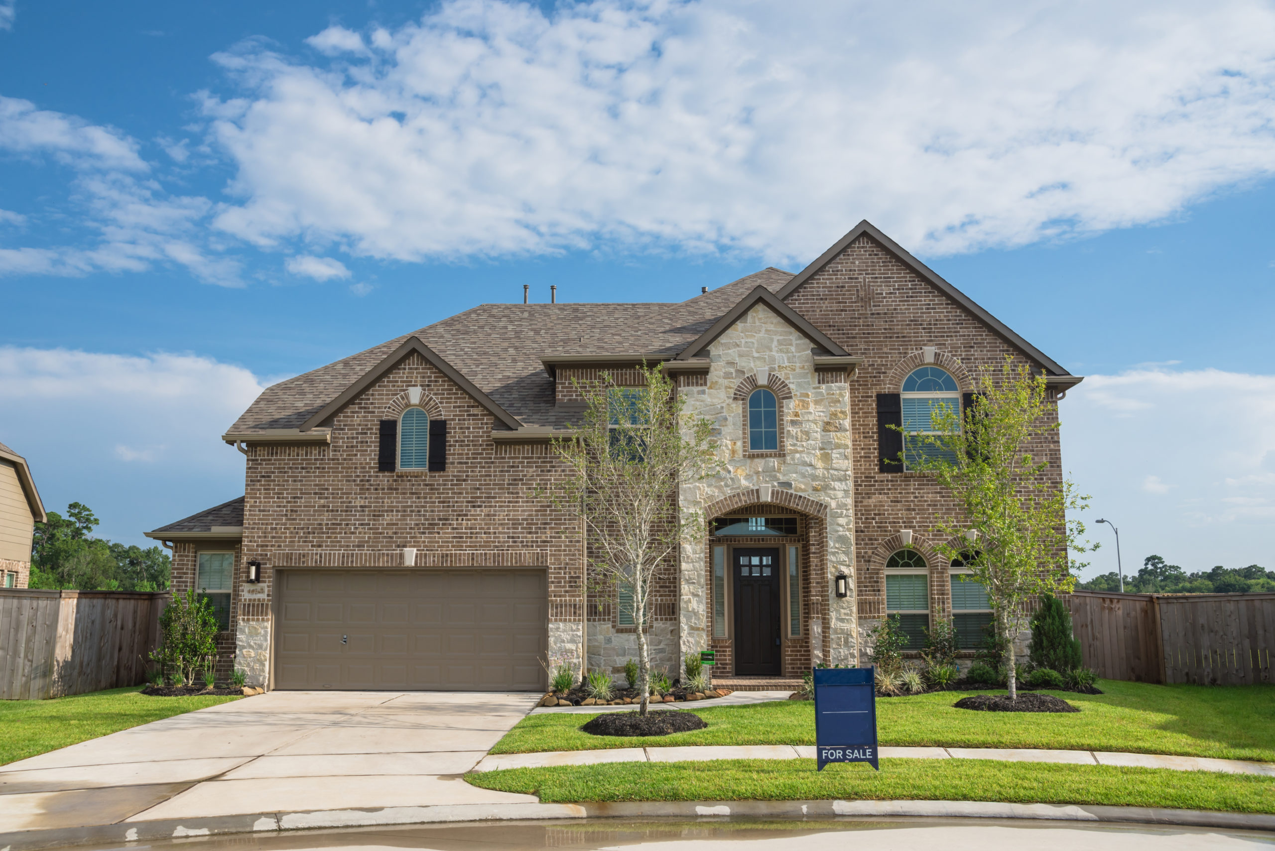 A house with a blue sign in front of it